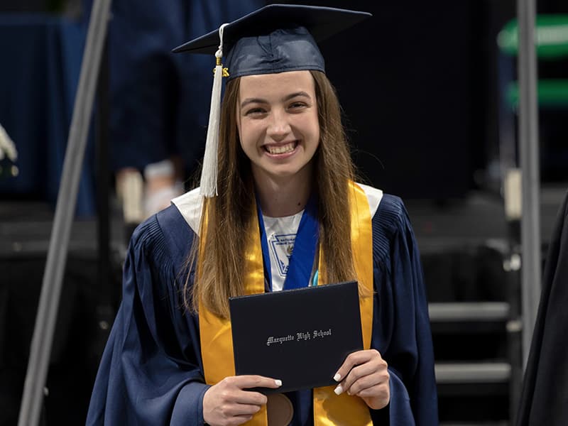 A Marquette High School graduate poses with her diploma