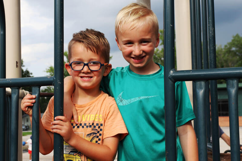 Two Ellisville students smile together on the school playground