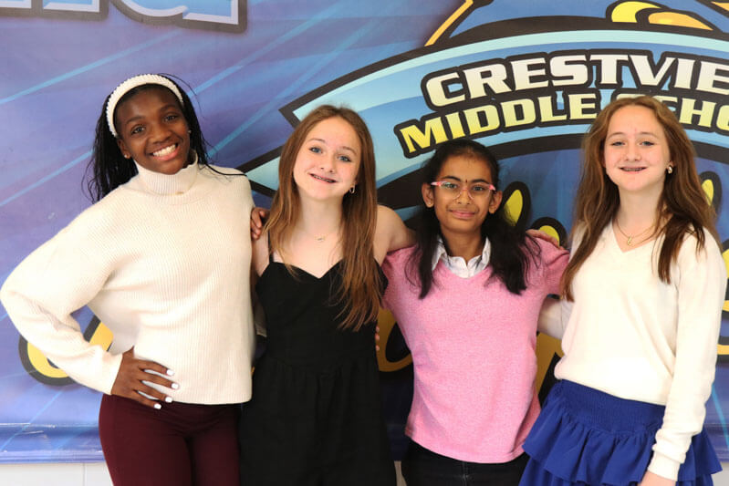 Two Crestview students smile while working together in class