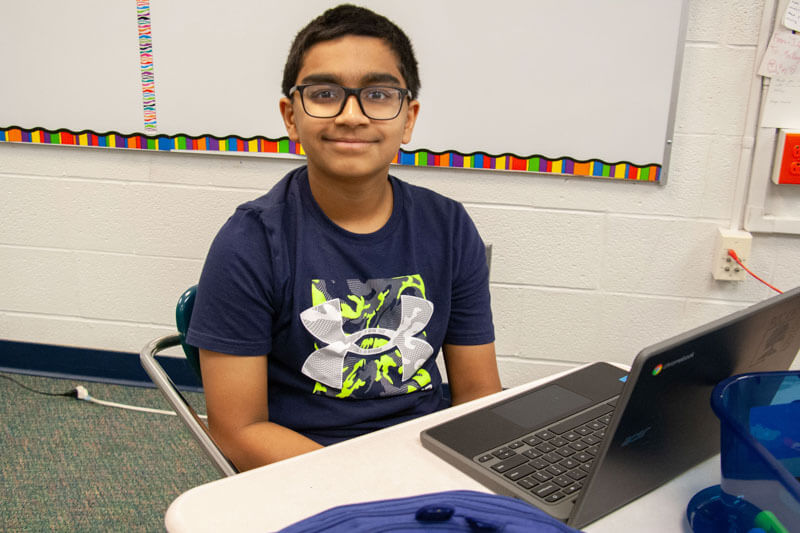 A Selvidge studentworks with his Chromebook in the classroom